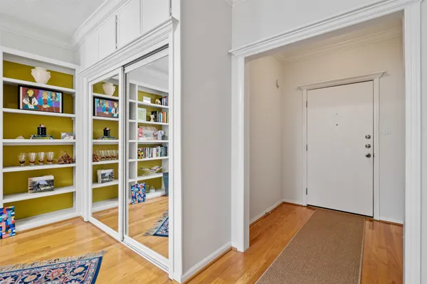 a view of a bedroom with wooden floor