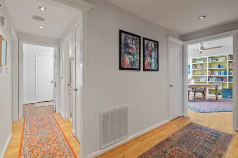 a living room with furniture and a book shelf
