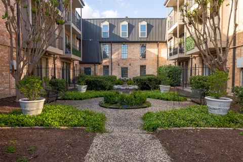a view of a patio with couches and table potted plants with wooden floor and fence