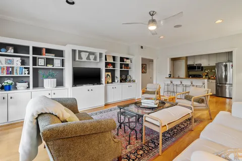 a living room with furniture workspace and a flat screen tv