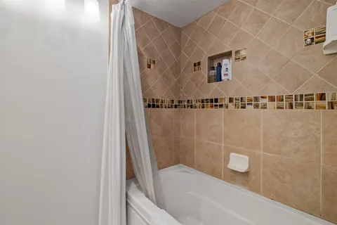 a view of bedroom with a bed and a book shelf