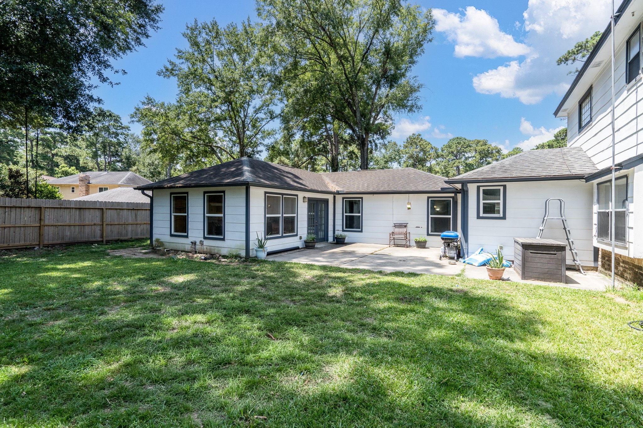6527 Castle Pine Lane Spring, TX 77379 - Photo 4 of 47 The nicely shaded backyard provides a peaceful outdoor retreat, perfect for relaxing, entertaining, or enjoying time with family and friends.