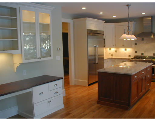 14 Slocum Road Lexington, MA 02421 - Photo 6 of 8 a kitchen with kitchen island granite countertop a refrigerator and a sink