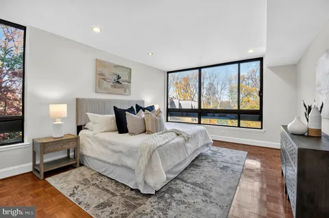 a bedroom with a large bed and a large window