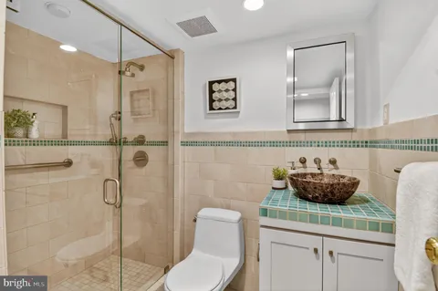 a bathroom with a toilet sink and shower