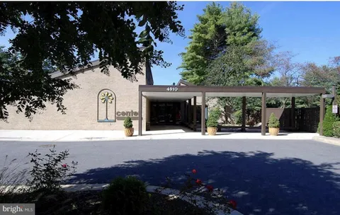 a view of house with outdoor space and parking