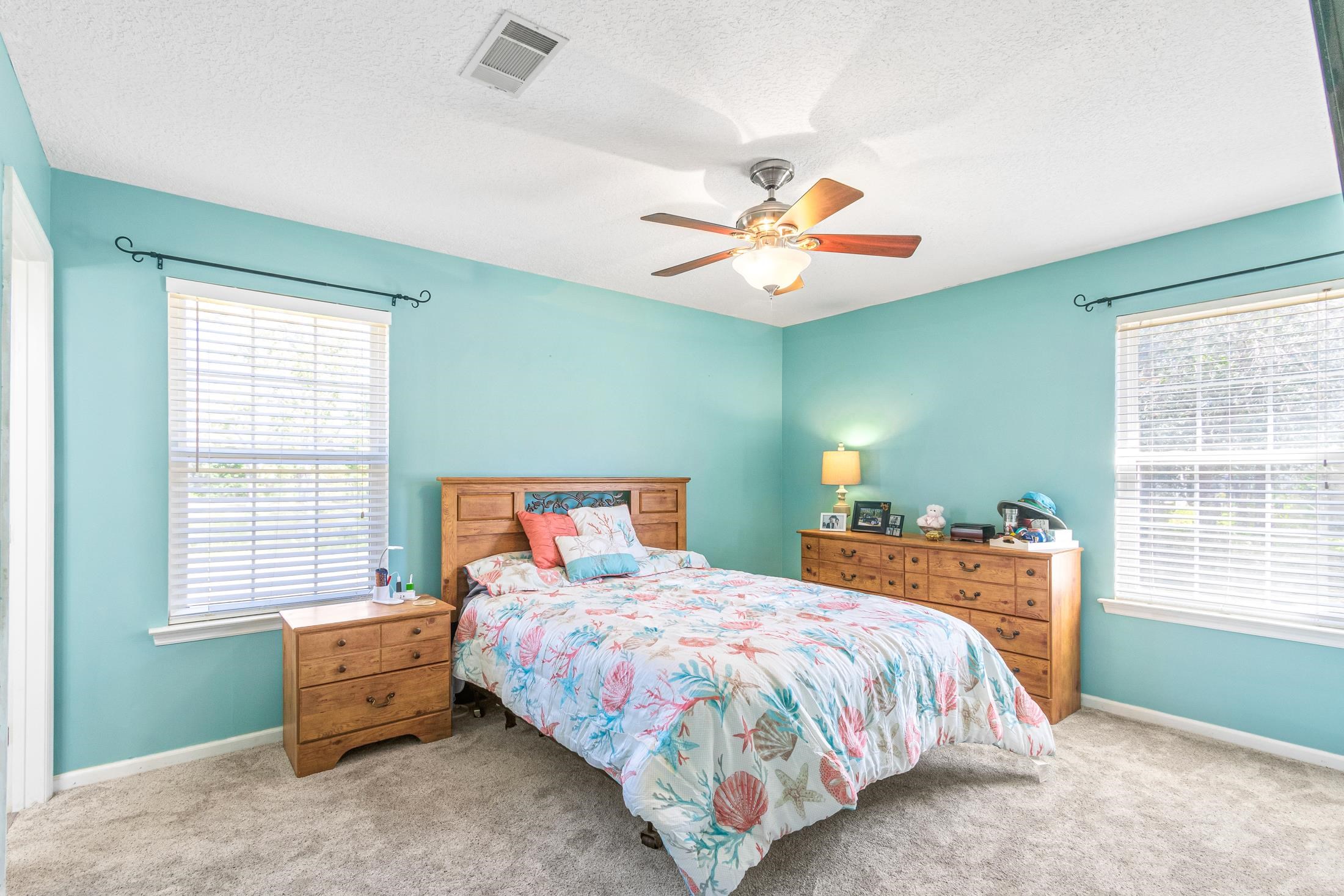 6632 Brown Road St. Augustine, FL 32095 - Photo 25 of 40 a bedroom with a bed and a chandelier