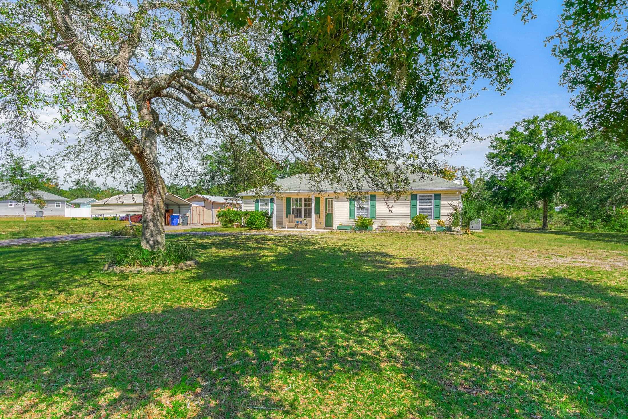 6632 Brown Road St. Augustine, FL 32095 - Photo 3 of 40 a front view of a house with garden