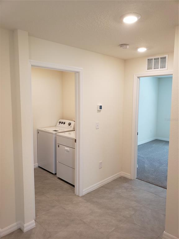 12211 Kingsley Trail Parrish, FL 34219 - Photo 4 of 28 a utility room with cabinets washer and dryer