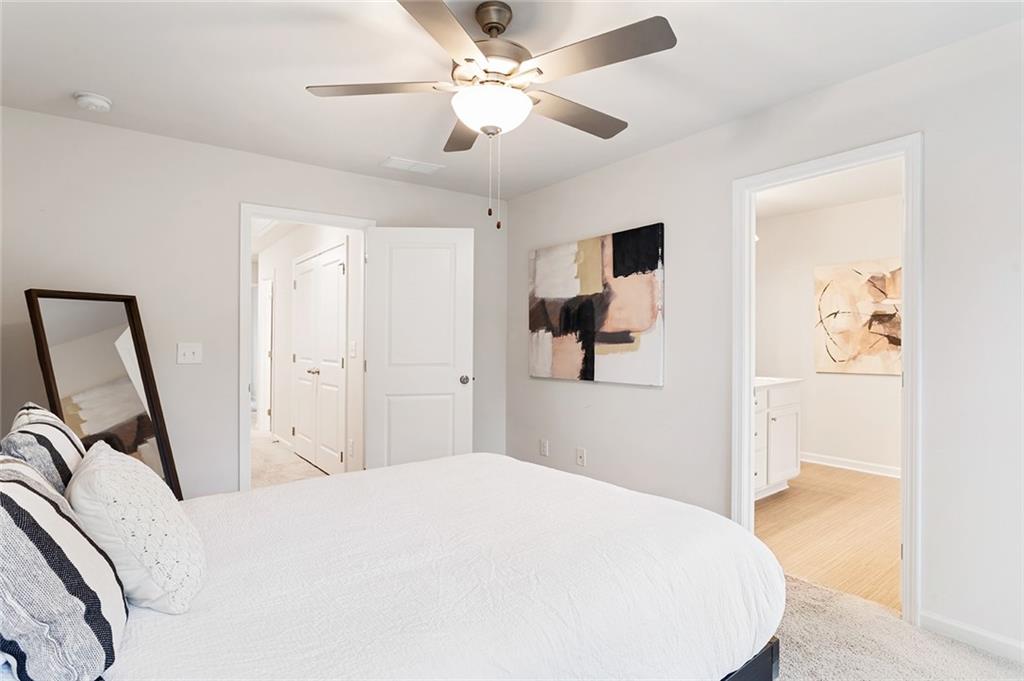 2824 Saratoga Lake View Decatur, GA 30034 - Photo 23 of 30 a bedroom with a bed and a chandelier