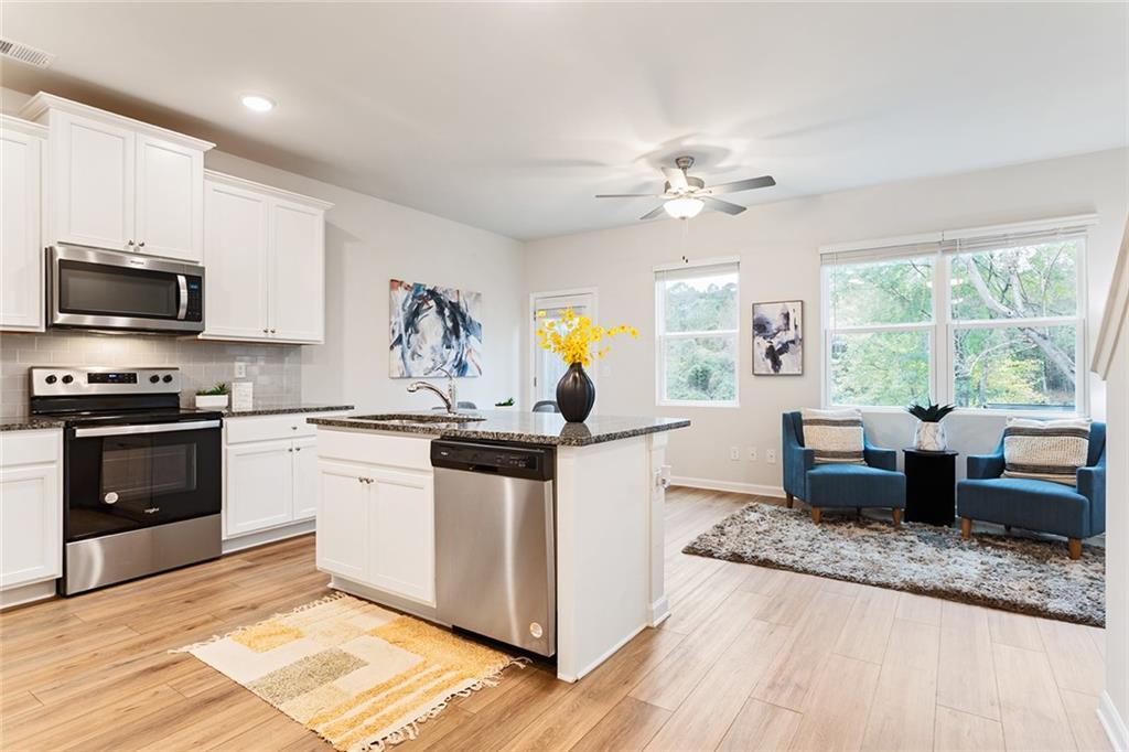 2824 Saratoga Lake View Decatur, GA 30034 - Photo 24 of 30 a kitchen with stainless steel appliances granite countertop a stove a sink and a microwave