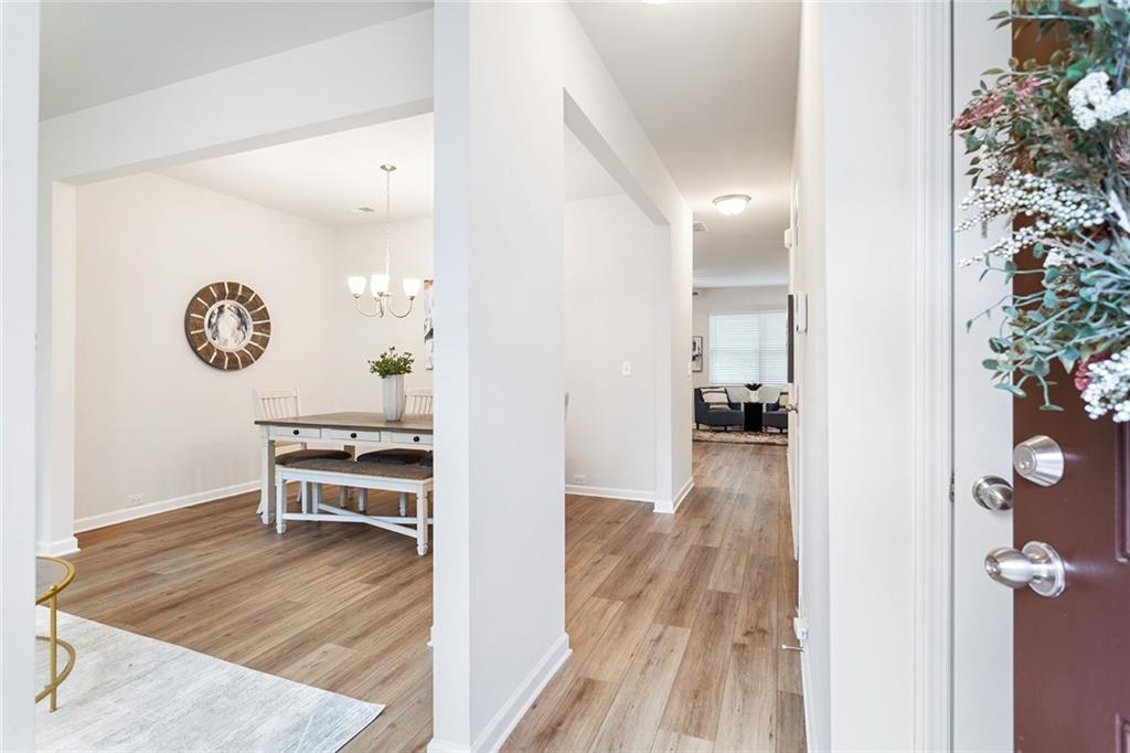 2824 Saratoga Lake View Decatur, GA 30034 - Photo 25 of 30 a view of a hallway with wooden floor and a living room