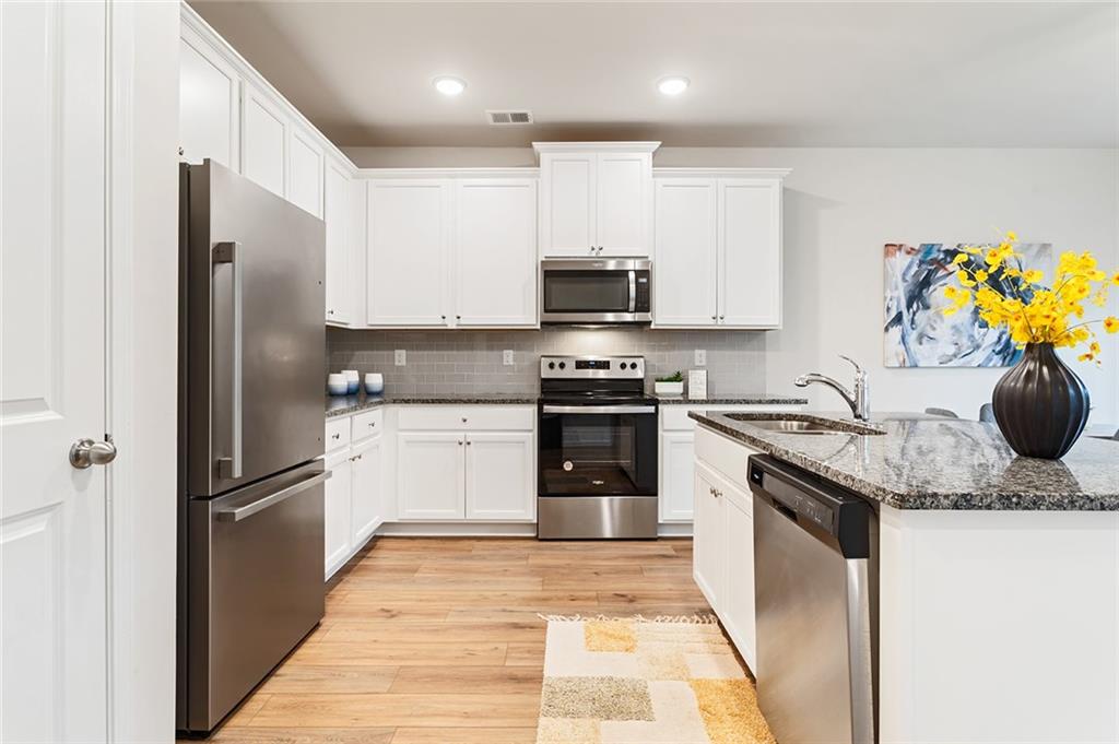 2824 Saratoga Lake View Decatur, GA 30034 - Photo 5 of 30 a kitchen with stainless steel appliances granite countertop a refrigerator sink and stove