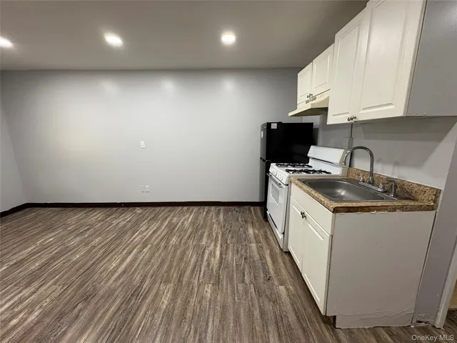 a kitchen with stove and cabinets