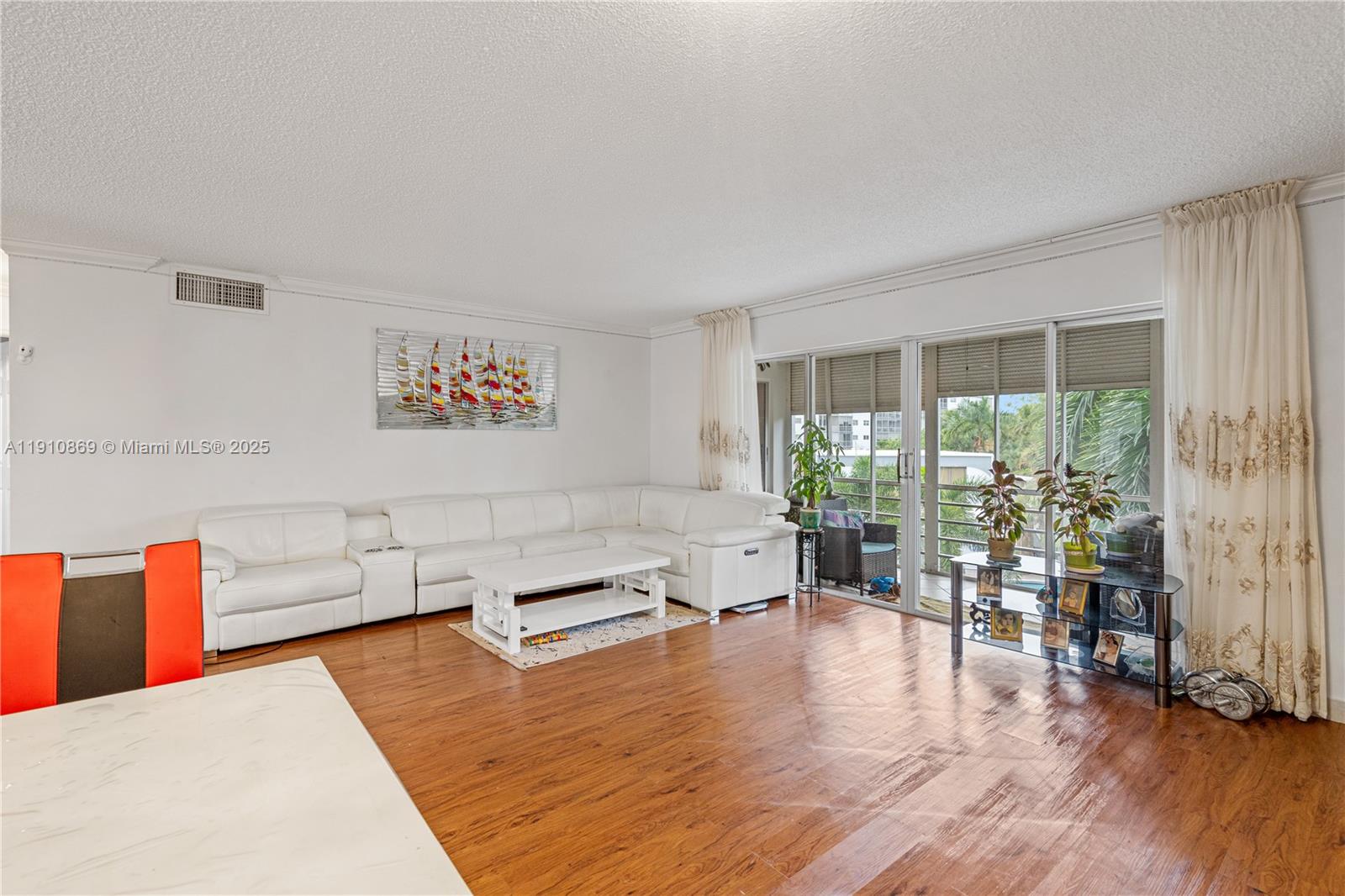 1425 Atlantic Shores Boulevard, Unit 409 Hallandale Beach, FL 33009 - Photo 11 of 30 a living room with furniture and a large window