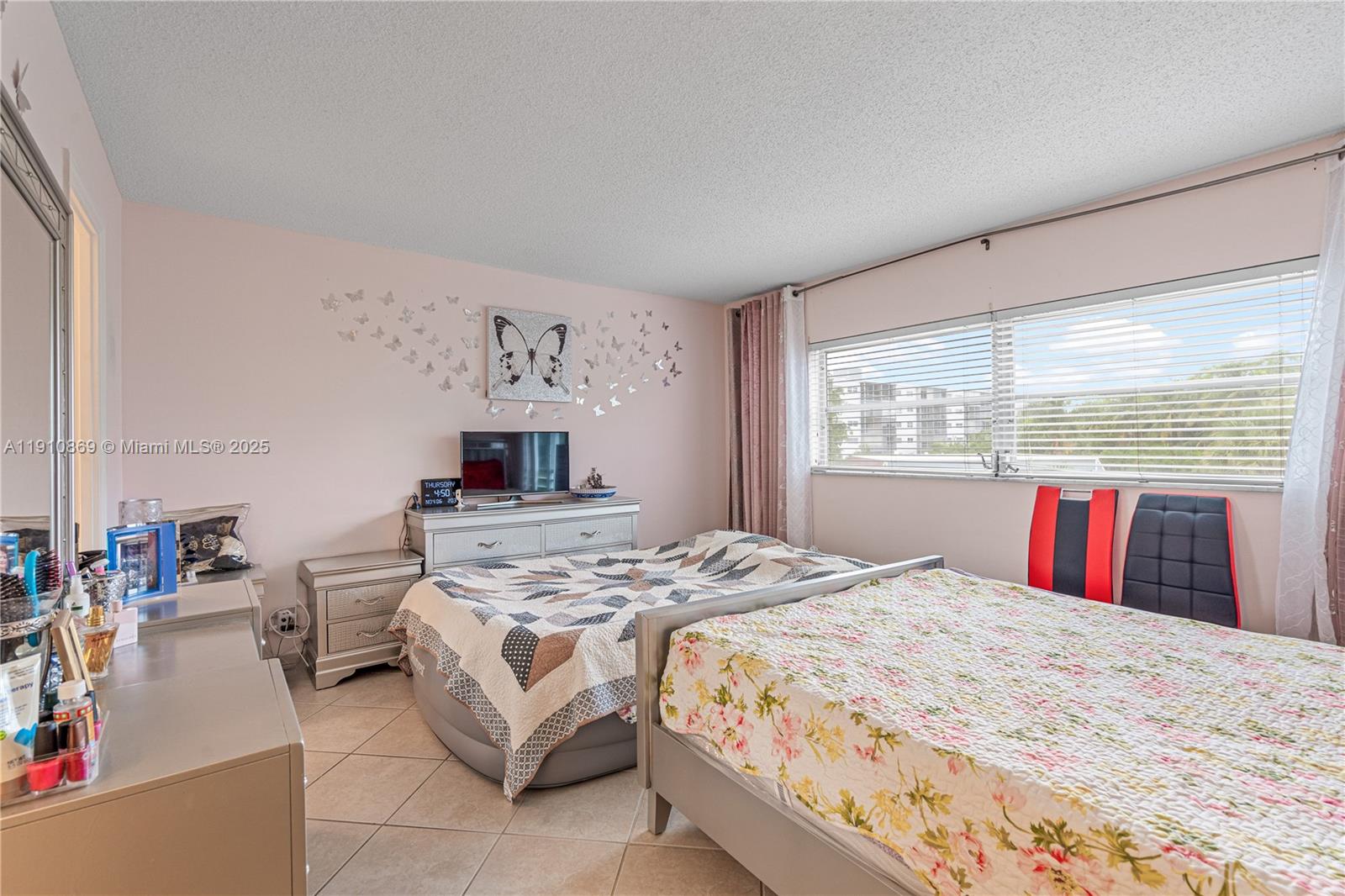 1425 Atlantic Shores Boulevard, Unit 409 Hallandale Beach, FL 33009 - Photo 19 of 30 a bedroom with a large bed and a window