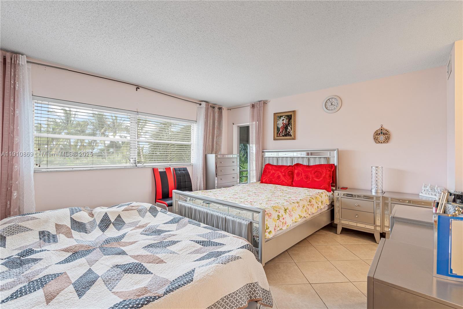 1425 Atlantic Shores Boulevard, Unit 409 Hallandale Beach, FL 33009 - Photo 20 of 30 a bedroom with two beds and a window