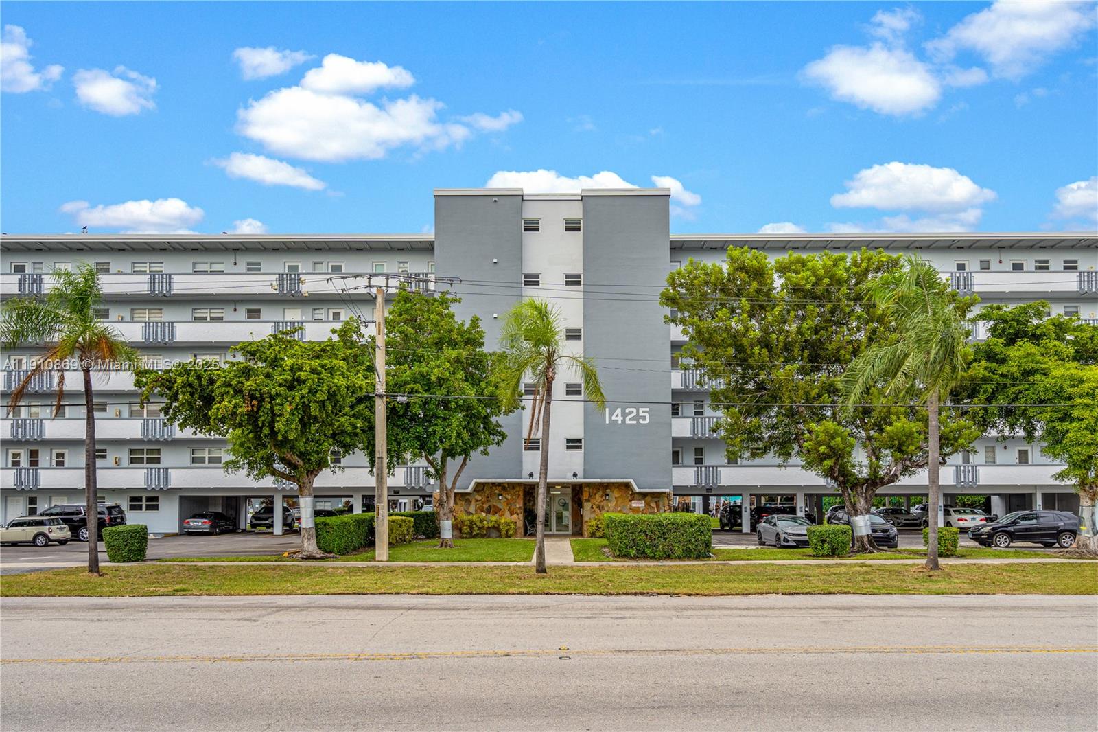 1425 Atlantic Shores Boulevard, Unit 409 Hallandale Beach, FL 33009 - Photo 2 of 30 a view of a tall building next to a yard