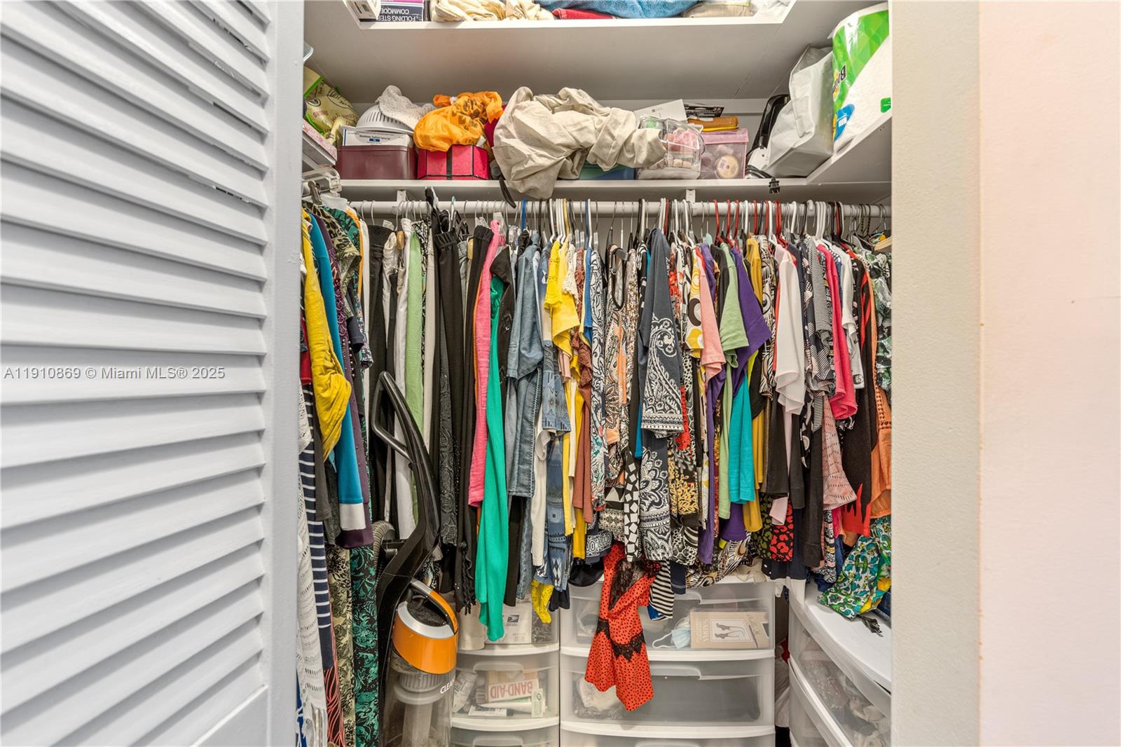 1425 Atlantic Shores Boulevard, Unit 409 Hallandale Beach, FL 33009 - Photo 22 of 30 a view of walk in closet with clothes