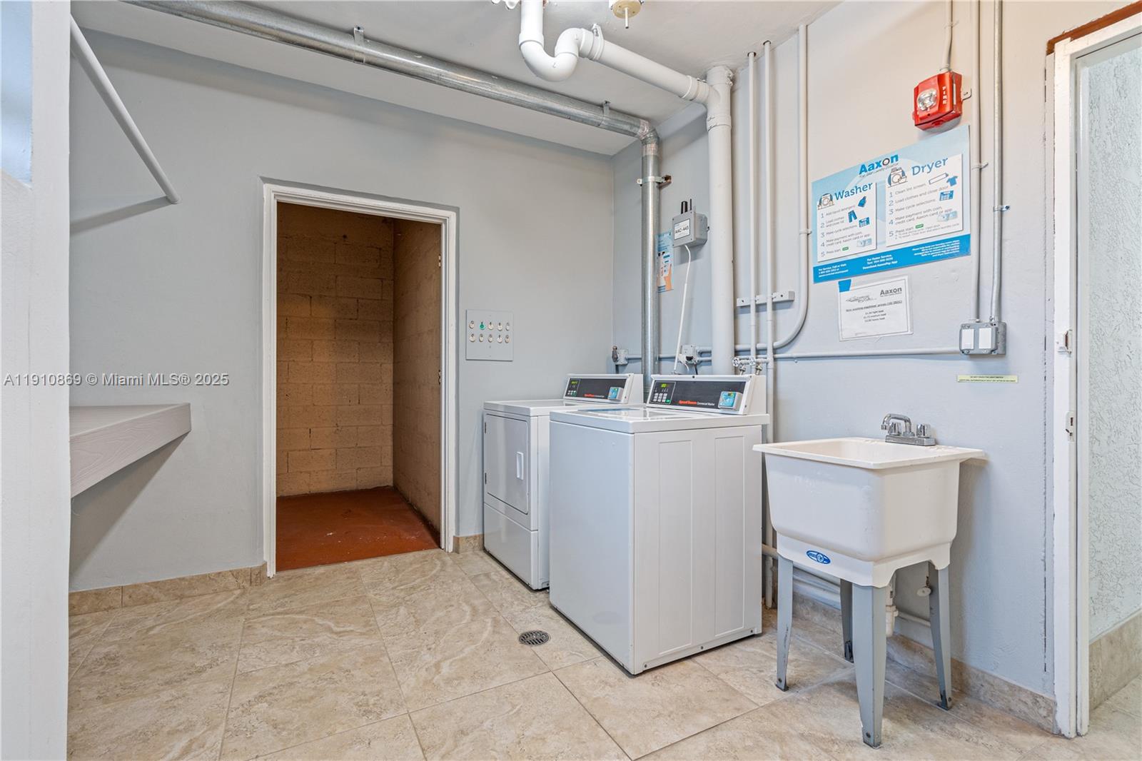 1425 Atlantic Shores Boulevard, Unit 409 Hallandale Beach, FL 33009 - Photo 27 of 30 a utility room with dryer and washer