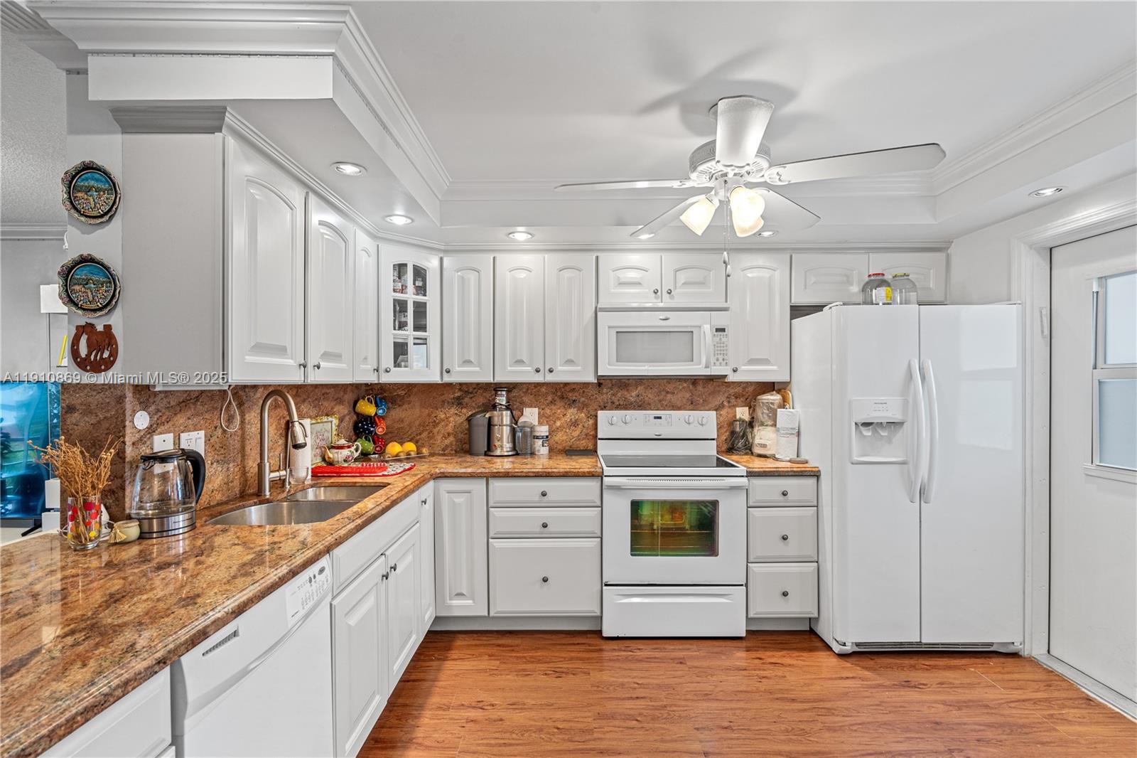 1425 Atlantic Shores Boulevard, Unit 409 Hallandale Beach, FL 33009 - Photo 4 of 30 a kitchen with stainless steel appliances a stove a sink and a refrigerator