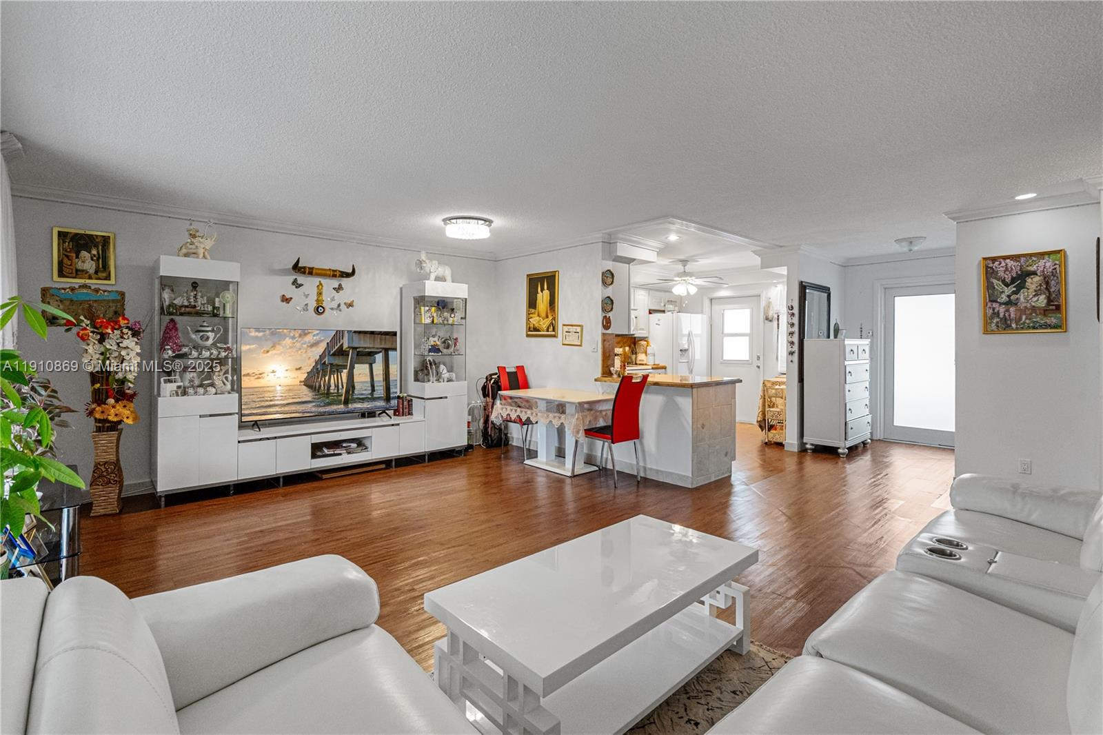 1425 Atlantic Shores Boulevard, Unit 409 Hallandale Beach, FL 33009 - Photo 6 of 30 a living room with furniture and a flat screen tv