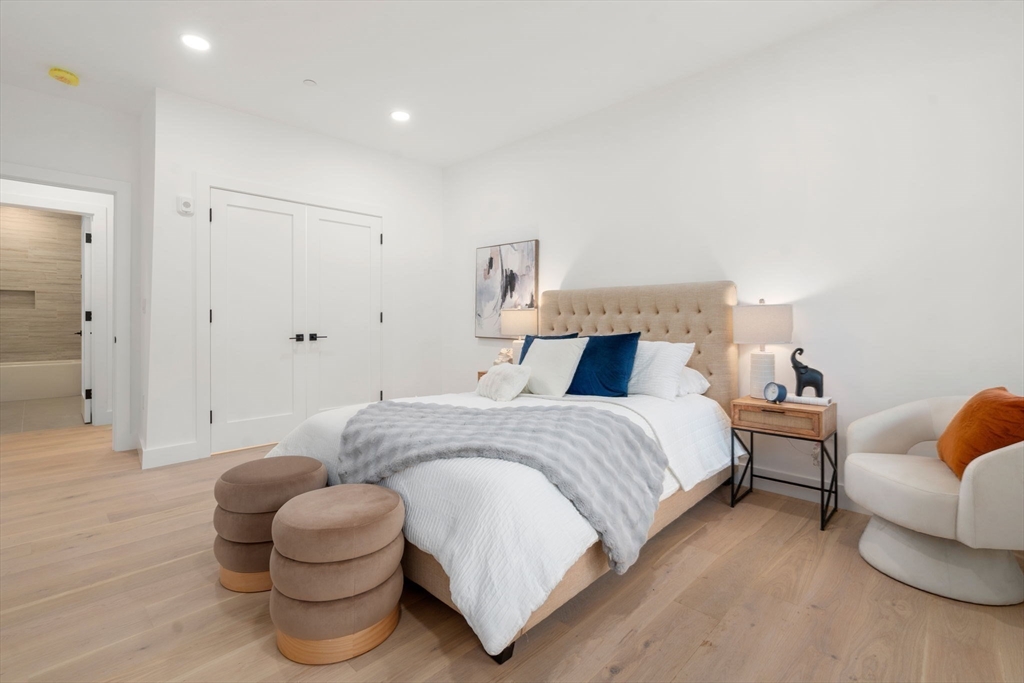 16 Stearns Road, Unit 301 Wellesley, MA 02482 - Photo 12 of 20 a spacious bedroom with a bed and a couch