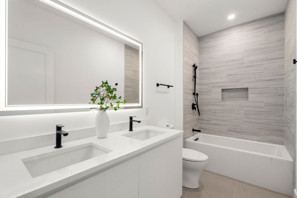 16 Stearns Road, Unit 301 Wellesley, MA 02482 - Photo 18 of 20 a bathroom with a sink a toilet and a bathtub