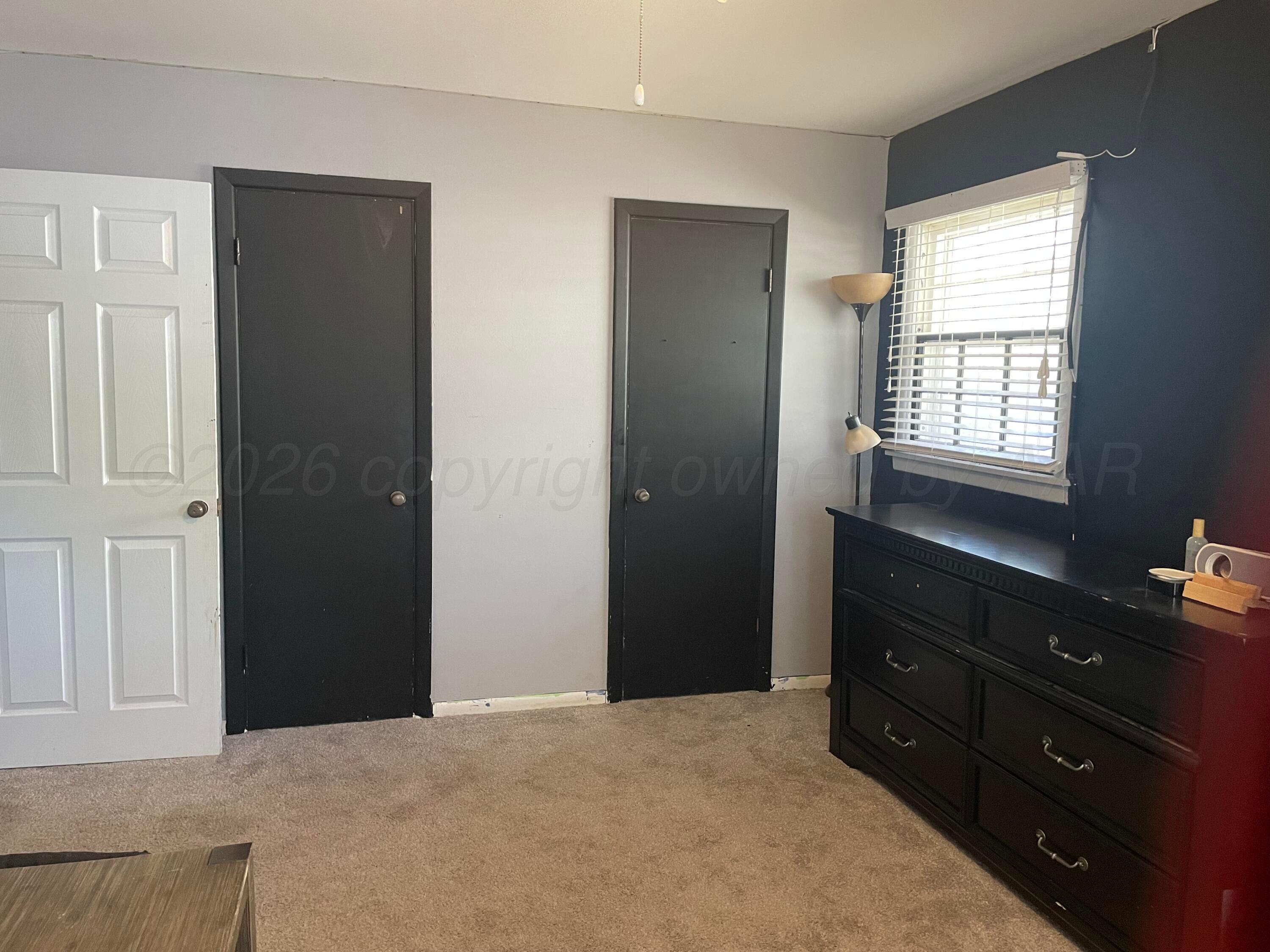 6200 Hanson Road Amarillo, TX 79106 - Photo 21 of 27 a bedroom with a bed and a dresser