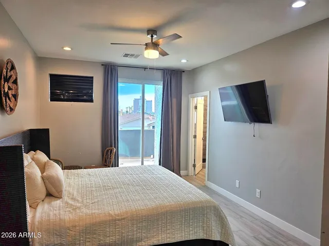 a bedroom with a bed and a flat screen tv