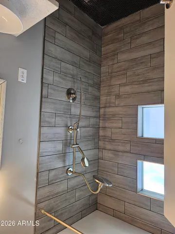 a bathroom with a shower a sink and a mirror