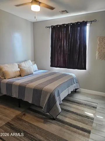 a bedroom with a bed and a window