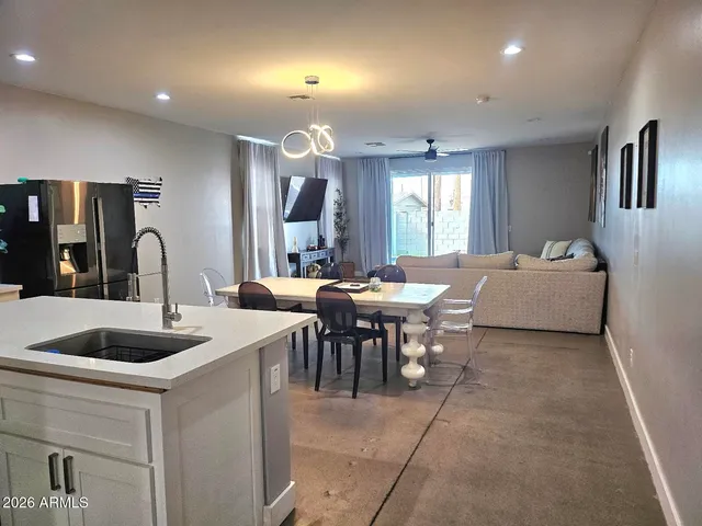 a kitchen with white cabinets and stove