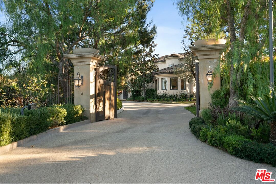 8 Beverly Ridge Terrace Beverly Hills, CA 90210 - Photo 2 of 74 a front view of a house with a yard and trees