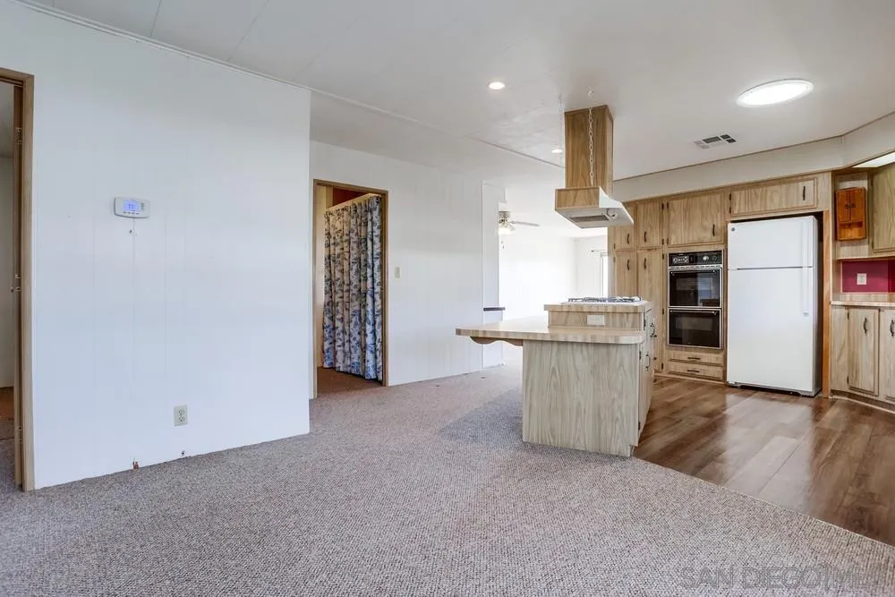 650 South Rancho Santa Fe Road, Unit 44 San Marcos, CA 92078 - Photo 15 of 25 a view of kitchen with refrigerator and window
