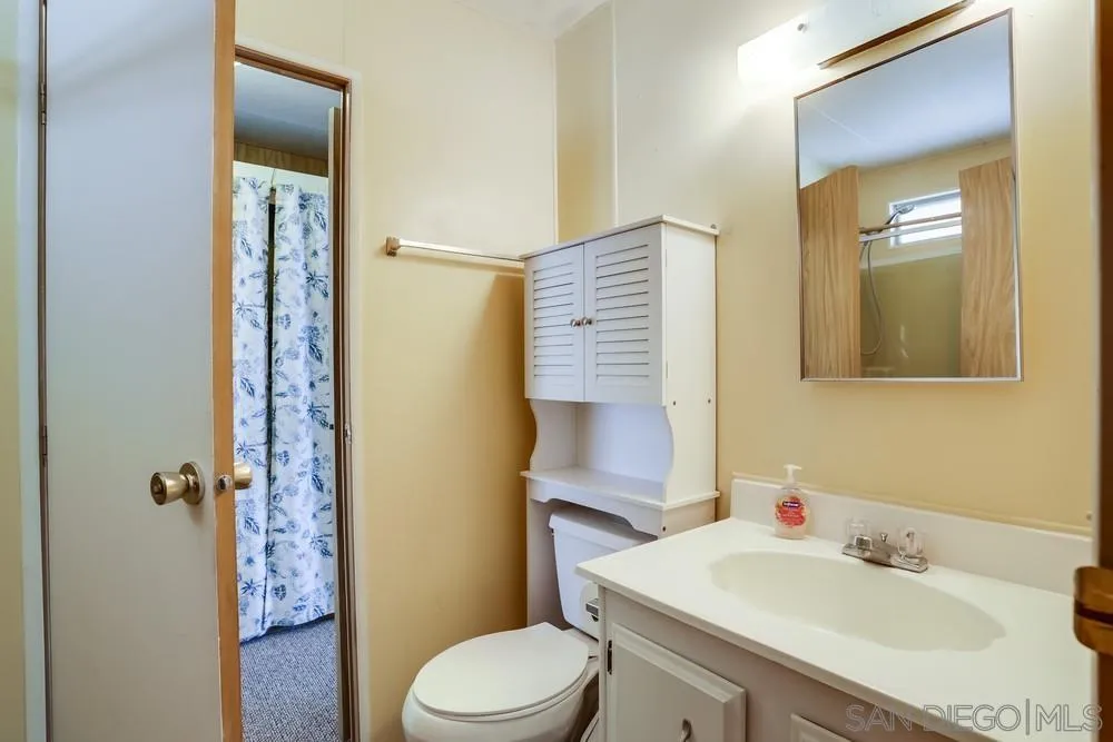 650 South Rancho Santa Fe Road, Unit 44 San Marcos, CA 92078 - Photo 21 of 25 a bathroom with a sink toilet and shower
