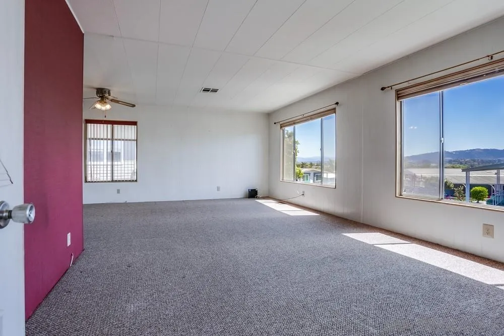 650 South Rancho Santa Fe Road, Unit 44 San Marcos, CA 92078 - Photo 6 of 25 an empty room with windows and closet