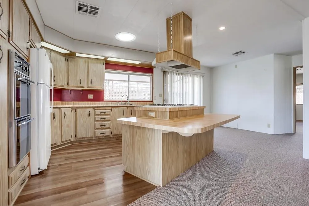 650 South Rancho Santa Fe Road, Unit 44 San Marcos, CA 92078 - Photo 10 of 25 a kitchen with stainless steel appliances granite countertop a sink a stove and a refrigerator