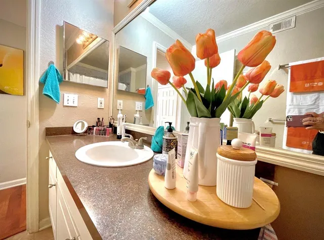 a dining room with furniture and a mirror