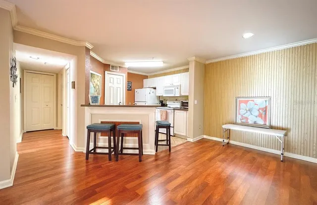 a view of a kitchen with dining table and wooden floor