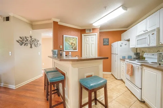 a kitchen with stainless steel appliances granite countertop a sink and a refrigerator