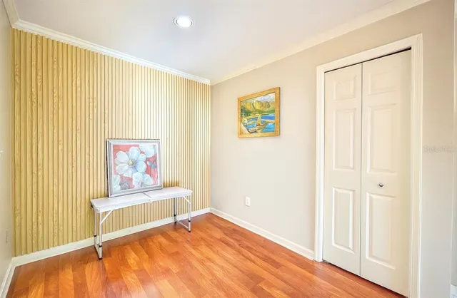 a view of a bedroom with wooden floor and bed