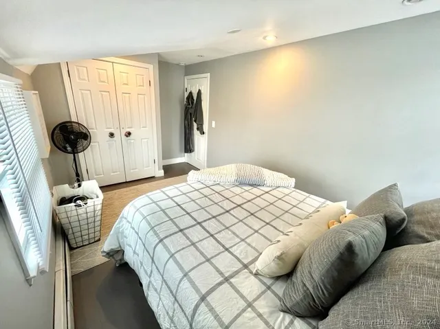 a bedroom with a bed and a window