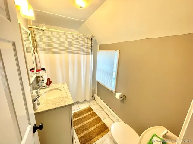 a bathroom with a sink a mirror and a shower