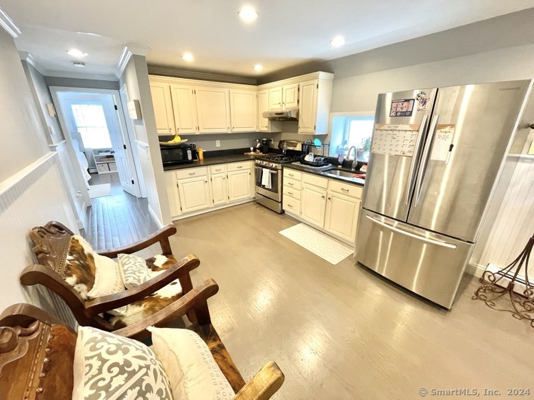 840 East Broadway, Unit 2 Milford, CT 06460 - Photo 7 of 15 a kitchen with a refrigerator a stove top oven and white cabinets