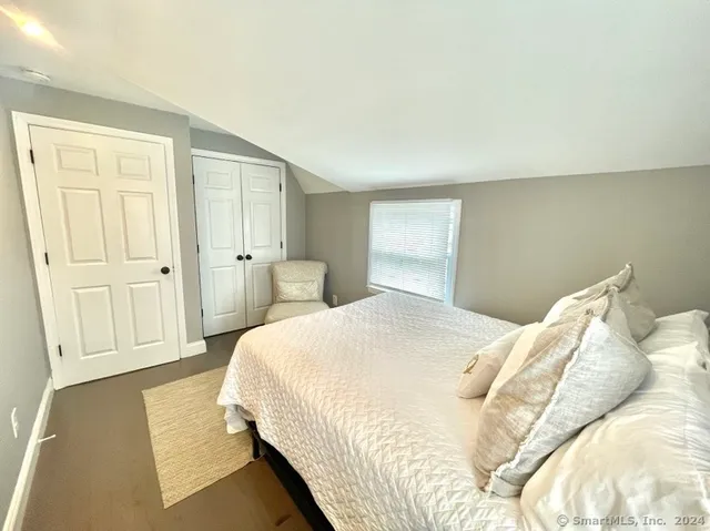 a bedroom with a bed and cabinets