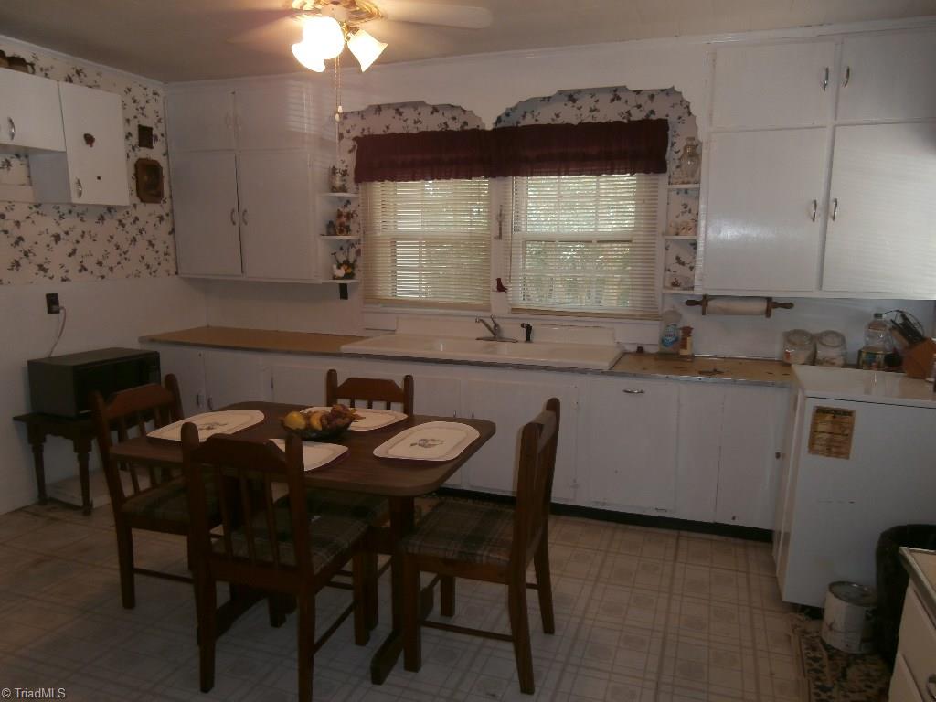 486 Jerry Frye Road Bennett, NC 27208 - Photo 2 of 16 Cute Eat-In Kitchen. Appliances Needed. Vinyl flooring. Formica Counter Top. Ample Cabinets for Storage.