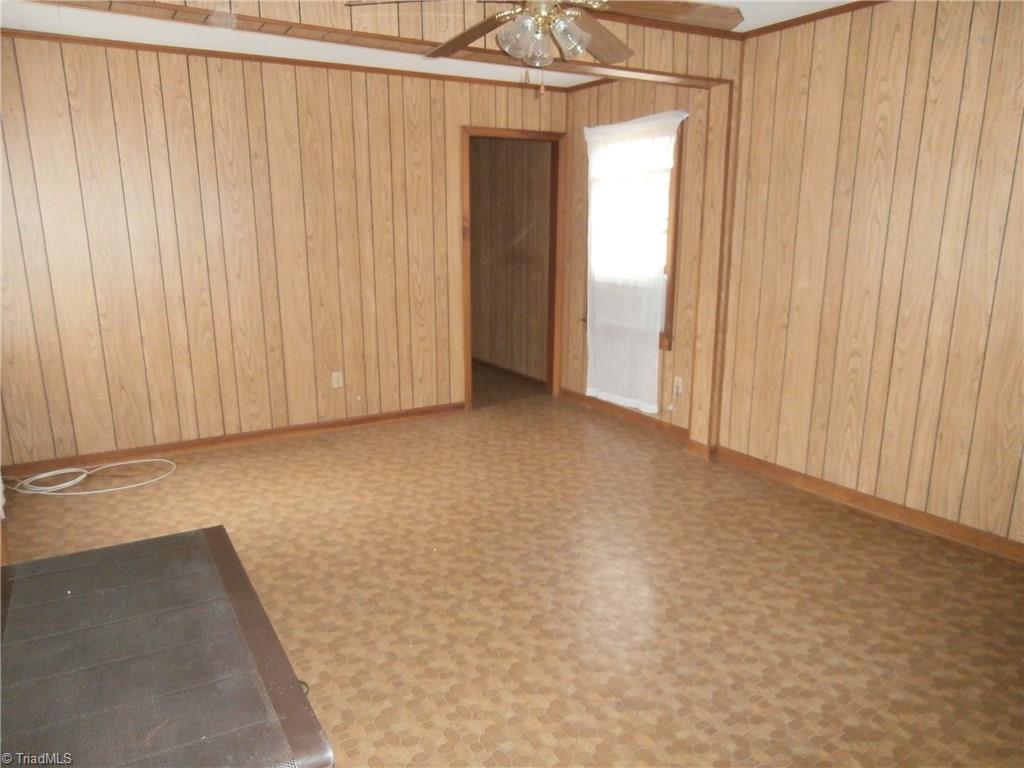 486 Jerry Frye Road Bennett, NC 27208 - Photo 5 of 16 Living Room. Free standing gas stove with thermostat. Window AC unit. Satellite TV hookup.