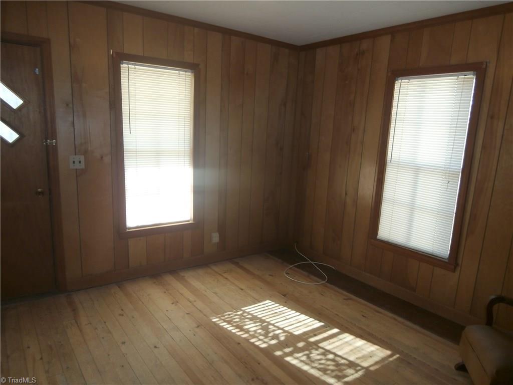 486 Jerry Frye Road Bennett, NC 27208 - Photo 9 of 16 Front Room - Used as Master Bedroom. Wood floor. Paneled. Window Blinds. No closets.