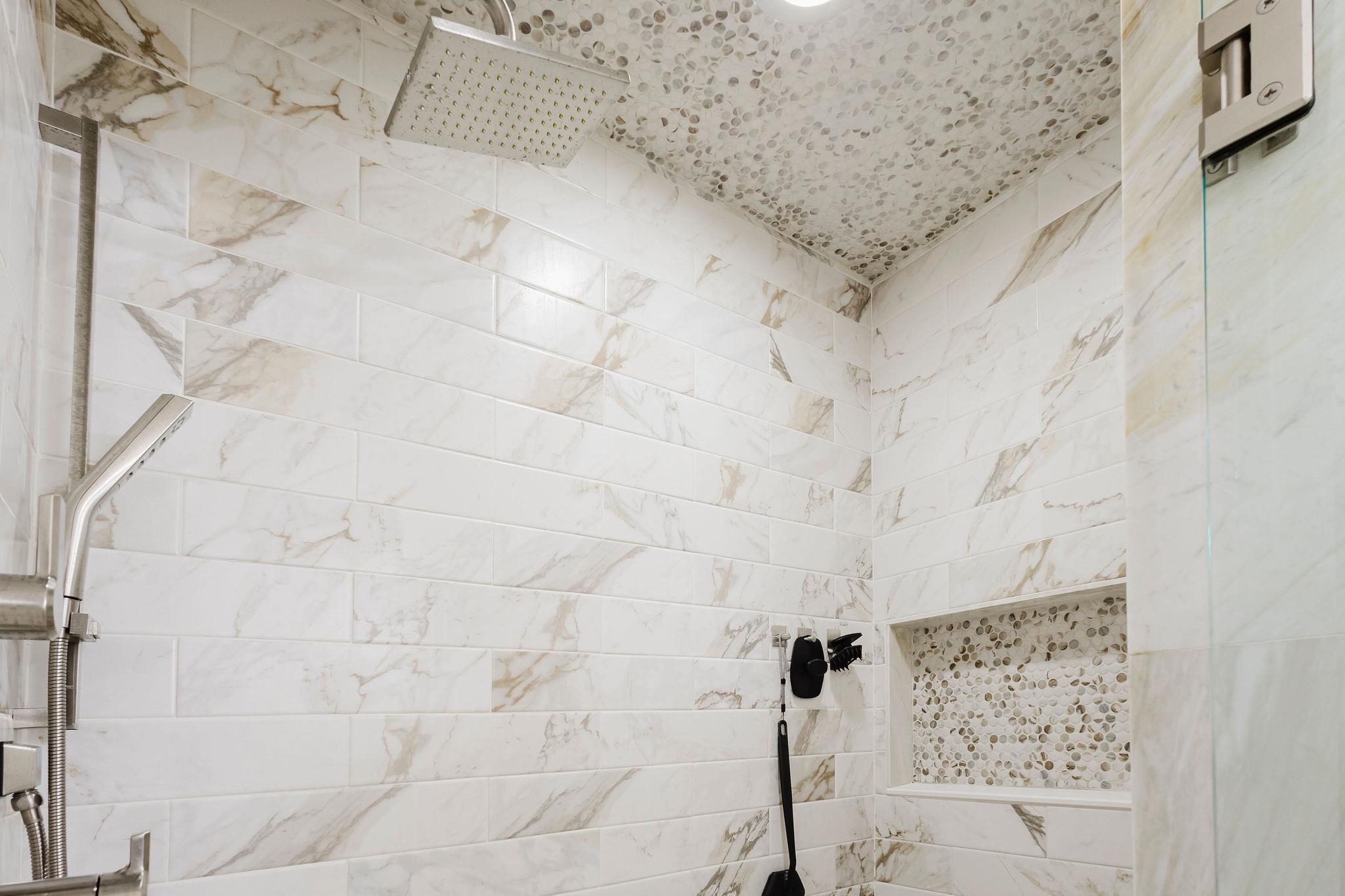 305 Great Falls Road Collierville, TN 38017 - Photo 12 of 23 Shower featuring large format rectangular tile walls, a mosaic pebble tile ceiling, and a built-in shower niche with mosaic pebble tile backing